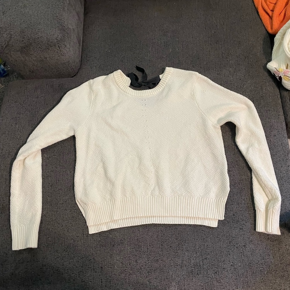 white sweater with black tie in back